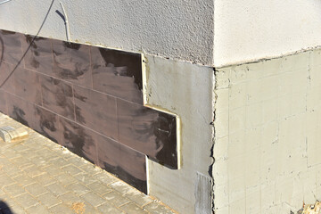 Insulation of walls cladding a ceramic tile. Modern metal facade tiles to repair and restore front side of building. Сomposite panels, resource conservation, material.