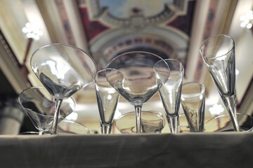 Various empty glasses on the table with blurred luxury interior