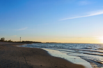 Sunset over the sea. Reflection of sunlight in the sea waves. The sky in the sunset rays.