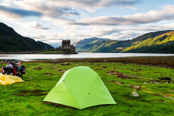 Lonely tent by Loch Duich, Scotland, United Kingdom, Europe. Eilean Donan castle in the background