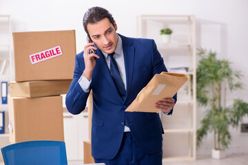 Young male logistics specialist working in the office