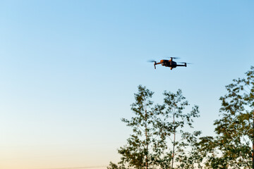 Drone flying on sky background
