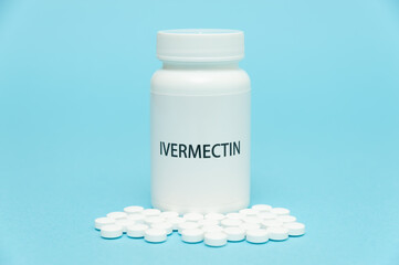 Treatments for Coronavirus (COVID-19): IVERMECTIN in white bottle packaging with scattered pills....