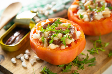 Stuffed premium tomato with beans, egg, and anchovies.