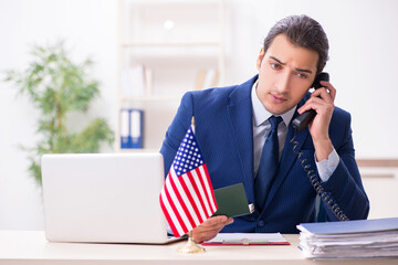 Young man checking passport at USA embassy