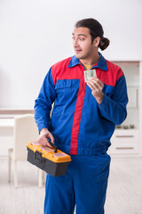 Young male carpenter working indoors