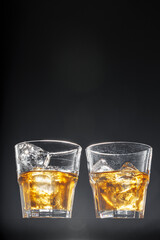 Glass of whisky on black background, copy space
