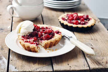 Baked mini tarts with raspberries.