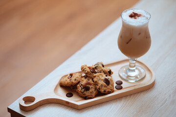 Cup of ice coffee and chocolate cookies for breakfast on wooden table