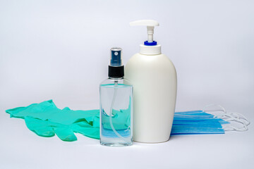 Fototapeta na wymiar bottle of lotion, sanitizer or liquid soap and protective mask over light grey background