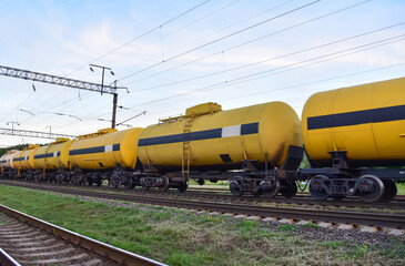 Fototapeta na wymiar Russian manufacturer and exporter of methanol. Chemical Cars on railway. Petroleum rail. The rolling stock with petrochemical tank cars. Transportation methanol tank wagons. Out of focus, motion