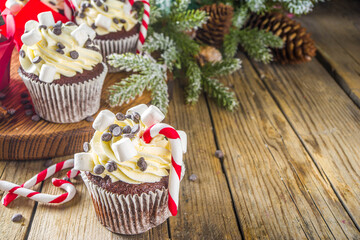 Christmas cupcakes. Xmas hot chocolate cupcake with peppermint candy cane, chocolate drops and...