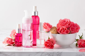 Obraz na płótnie Canvas bottles skincare lotion serum medical rose flowers. organic natural cosmetic