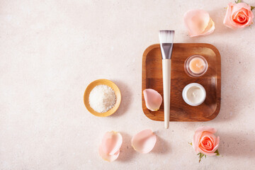 skincare products and rose flowers. natural cosmetics for home spa treatment