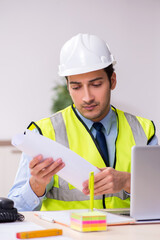 Young male architect working in the office