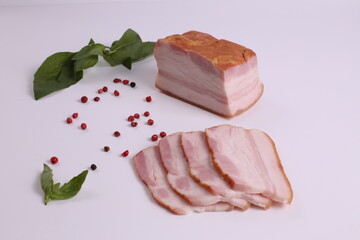 
bacon with basil leaves on white background