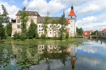 Fototapeta na wymiar View of the Blatna Castle in the Czech Republic with reflection in the water.