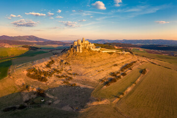 Spis Zipser Castle above valley at sunset or sunrise