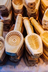 Vertical image of traditional wooden cookie molds with different carved designs