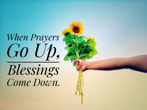 Inspirational quote - When prayers go up, blessings come down.  With hand holding bouquet of sunflowers against bright blue sky background. Prayer and blessing text message concept.