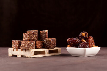 Healthy sweets. Dried fruit sweets (dried dates, prunes or apricots) with honey and nuts. Dark background. Selective focus. Copy space