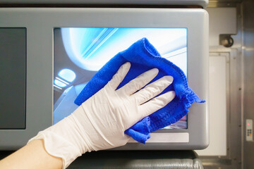 Close up hand is wearing gloves cleaning aircraft for covid-19 prevention pandemic
