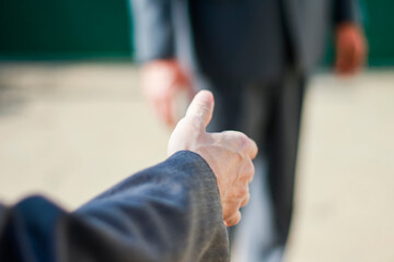 Handshake of businesspeople. Male and male hand makes a handshake in the office.