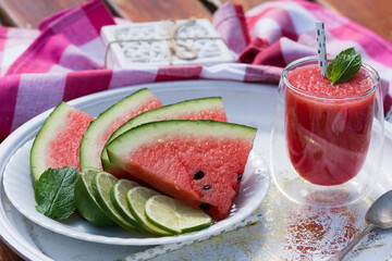 Watermelon smoothie garnished with fresh mint leaves - refreshing drink ideal for hot summer days.