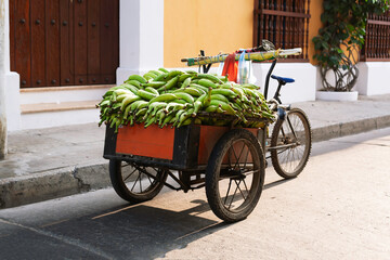 Fototapeta na wymiar Tricycle full of plantains for sale, Cartagena Old Town, Colombia