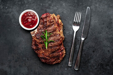 Marbled beef steak grill with spices on a stone background