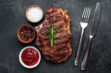 Marbled beef steak grill with spices on a stone background