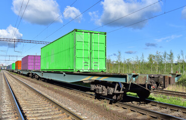 Fototapeta na wymiar Cargo Containers Transportation On Freight Train By Railway. Intermodal Container On Train Car. Rail Freight Shipping Logistics Concept. Out of focus, object in motion.