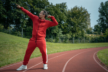 Obraz premium young cheerful personal fitness trainer at running track