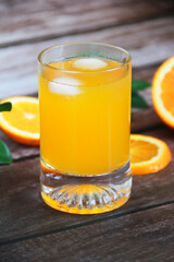 orange drink in a glass and slices of natural orange