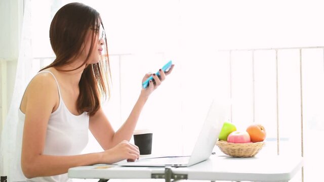 Woman using smartphone shopping online and call with technology lifestyle. Smiling face of asian woman holding cellphone with E-commerce Shopping online website Reading Online Article, Blog and vlog.