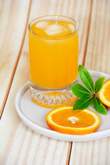 orange drink in a glass and slices of natural orange