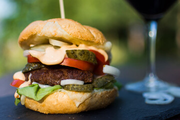 Homemade burger served in a garden.