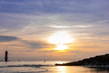 Early morning sunset / sunrise with Vew of volcano Agung mountains of Bali and sea and beach, Bali, Indonesia. Azure beach, rocky mountains in ocean in morning background