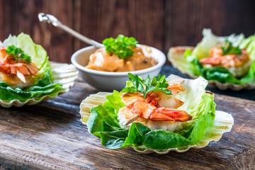 Canapes with grilled black tiger prawns and seafood sauce