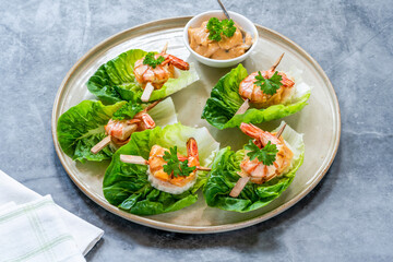Canapes with grilled black tiger prawns and seafood sauce