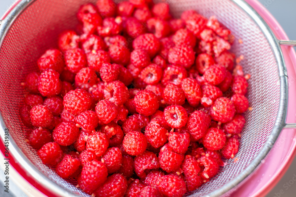Poster red raspberry berry in a bucket. the view from the top
