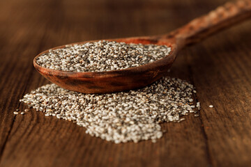 Wooden spoon with chia seeds close up