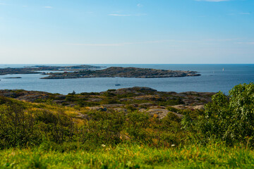 Sunny view over an archipelago. Sail boats crossing in the horizon