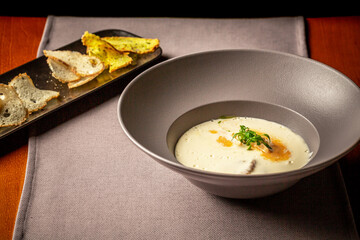 cheese soup with turkey fillet. restaurant food. author menu. Delicious homemade food. Croutons on the White Boards