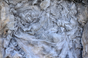 Gray background. Old glass wool.