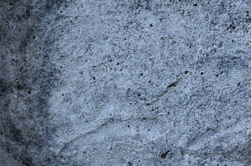 Gray background. Rusty concrete surface. The gravel in the cement, the pebbles.