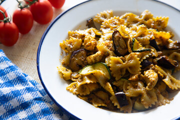 Italian pasta alla norma, farfalle with pesto rosso and eggplant.