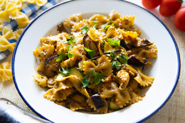 Italian pasta alla norma, farfalle with pesto rosso and eggplant.