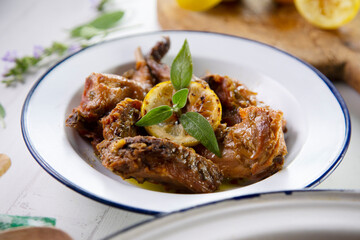 Wild rabbit cooked with lemon and salvia