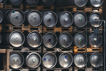 Metal barrel. Keg with beer. A large number. Stock. Logistics and alcohol concept. Wooden pallets.
